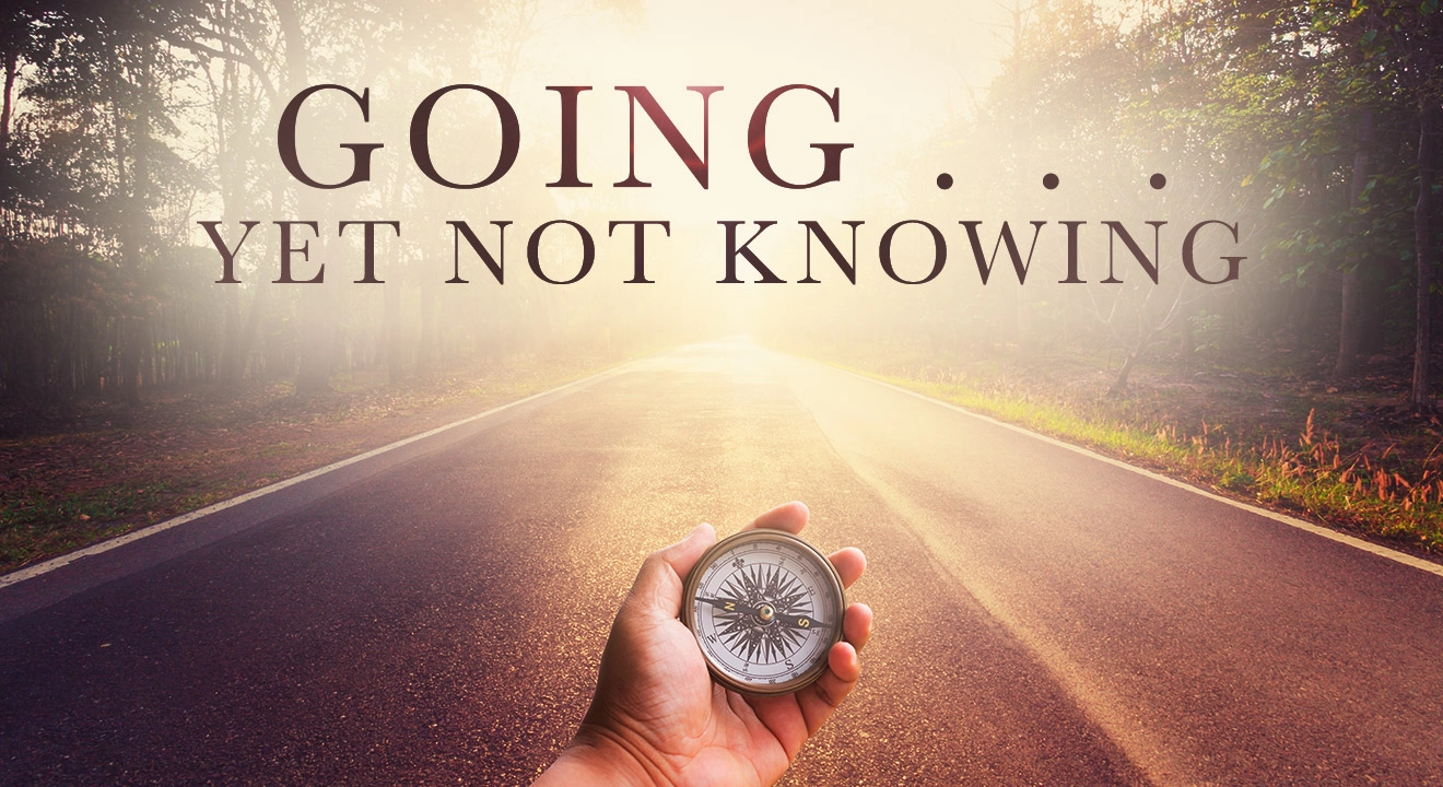 A man holding a compass on a street