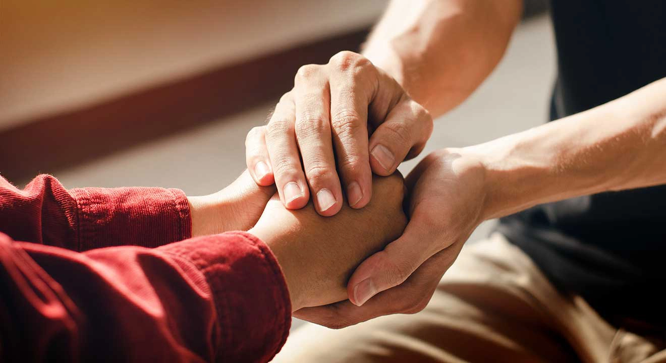 Close up of hands gripping another's hands