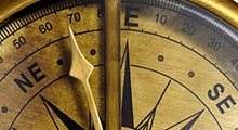 Close up of a compass pointing NE