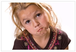 A young girl whose cheeks appear to be full