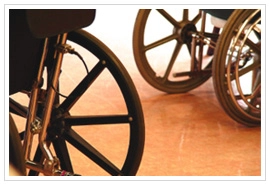 Closeup near the floor of a couple wheelchair wheels