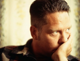 Man leaning his head on his left hand