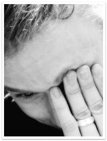 A married person with their left hand covering their eye