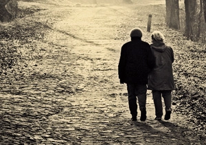 A couple bundled up walking down a path