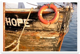 An old ship named Hope docked on a pier