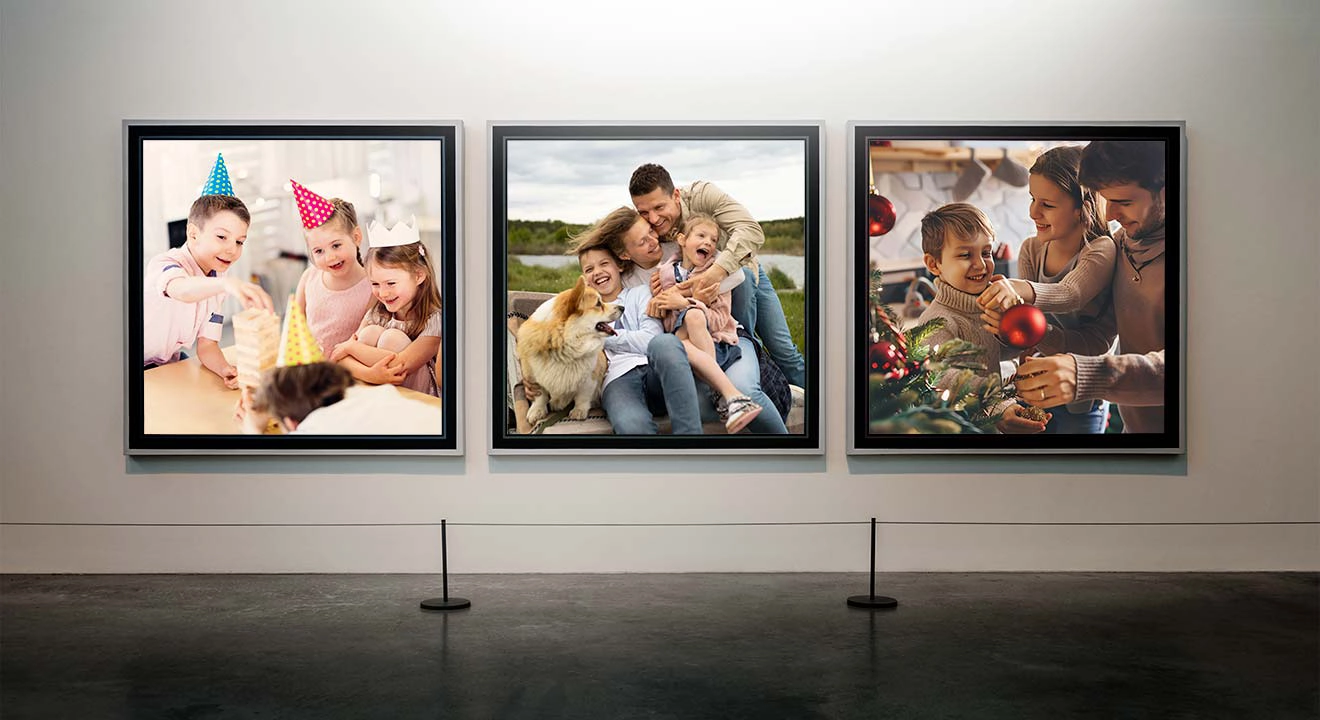 Three framed photographs on a museum wall