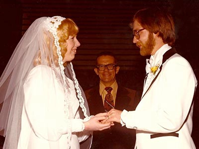 A bride and groom holding hands at a wedding