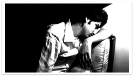 A man leaning on his left arm on a chair