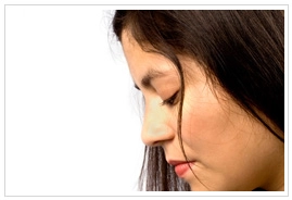 A profile of a young woman looking downward