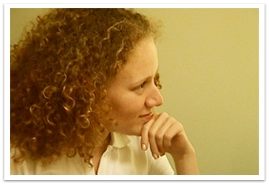 A woman with her left hand on her chin