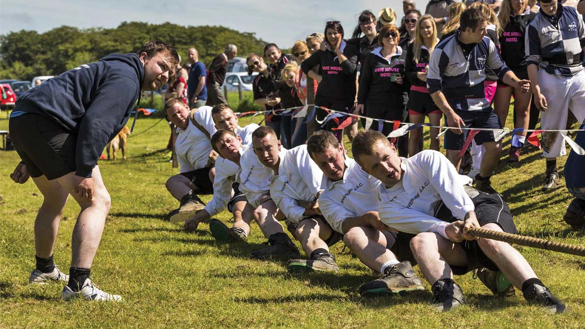 Men pulling a rope in a tug of war