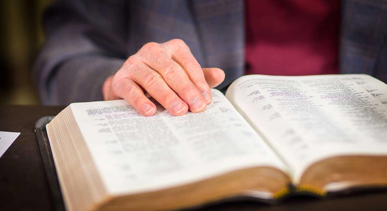 Hand on an open bible